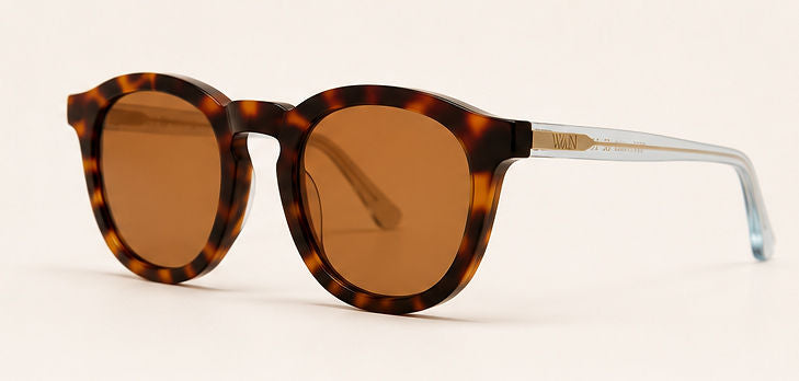 Wink & Nod Amalfi sunglasses in Havana with translucent blue temples, brown lenses — three-quarter view