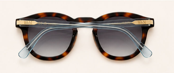 Wink & Nod Amalfi sunglasses in Havana with translucent blue temples, brown lenses — three-quarter view