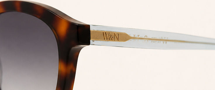 Wink & Nod Amalfi sunglasses in Havana with translucent blue temples, gray lenses — temple detail with gold W&N logo