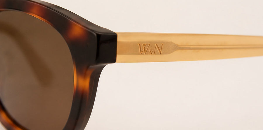 Wink & Nod Positano sunglasses in Havana with frosted amber temples, brown lenses — temple detail with gold W&N logo